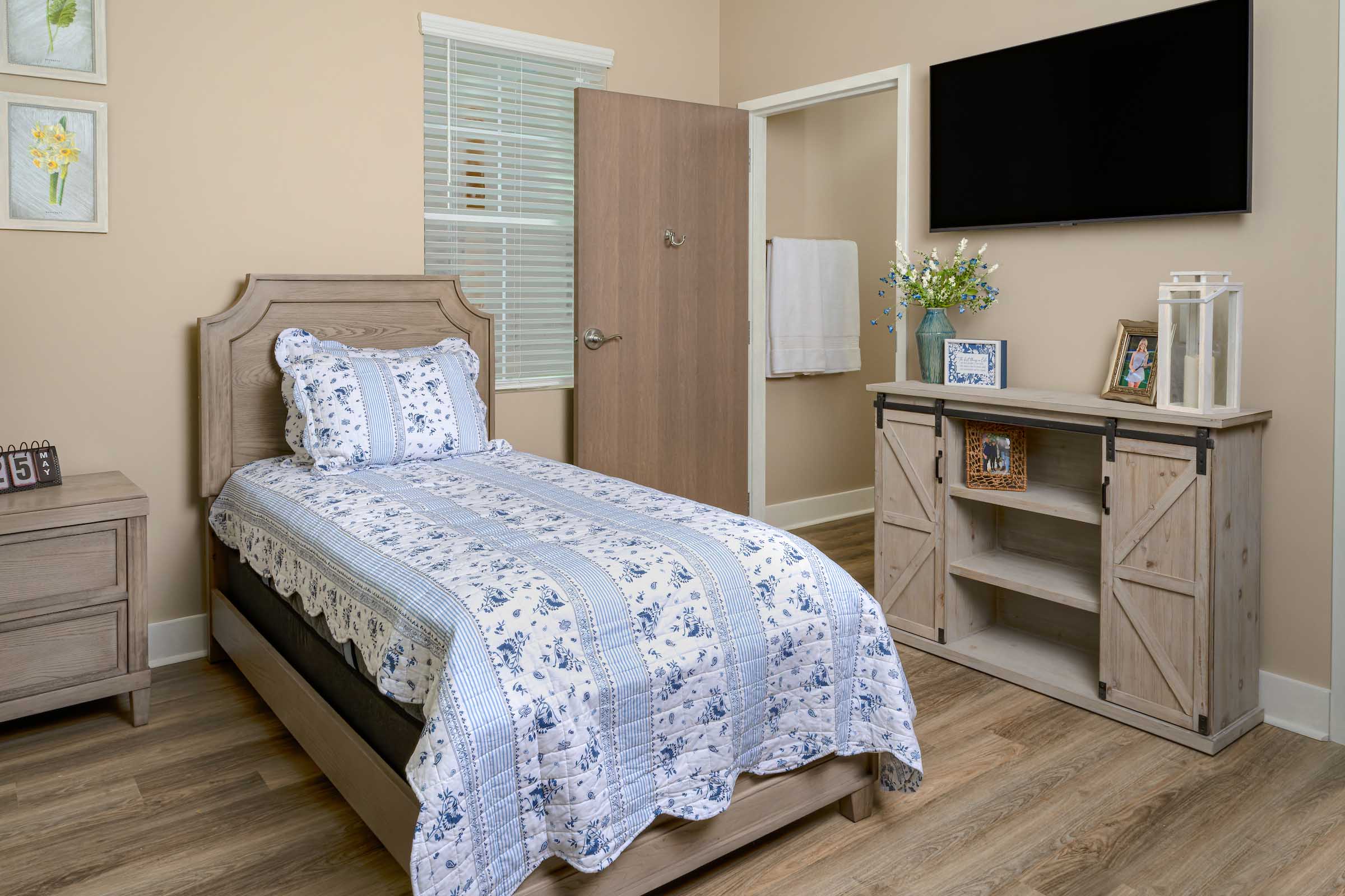 Willows-Interior-236 a bed with a tv in the corner of the room