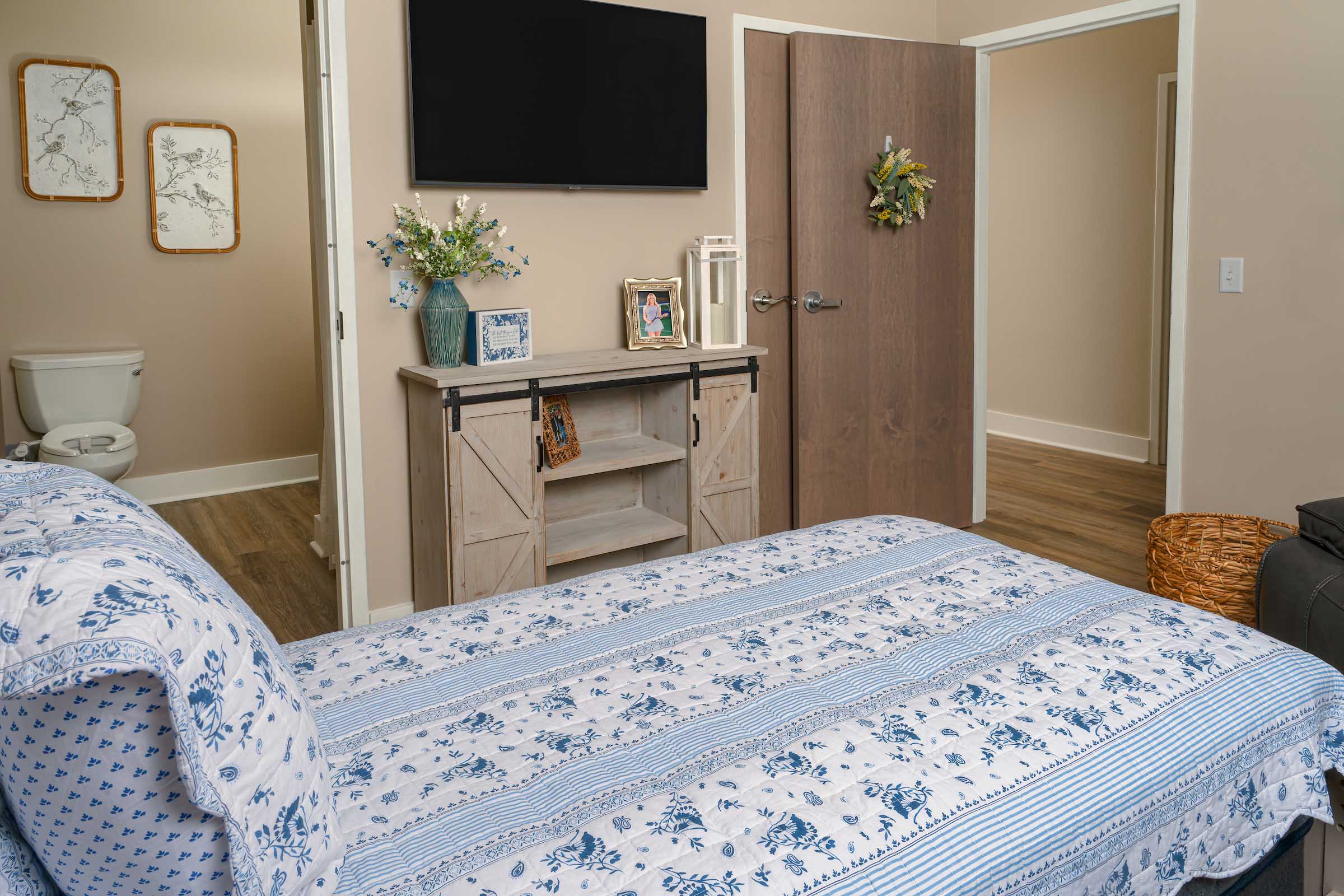 Willows-Interior-237 a bedroom with a tv and a bed